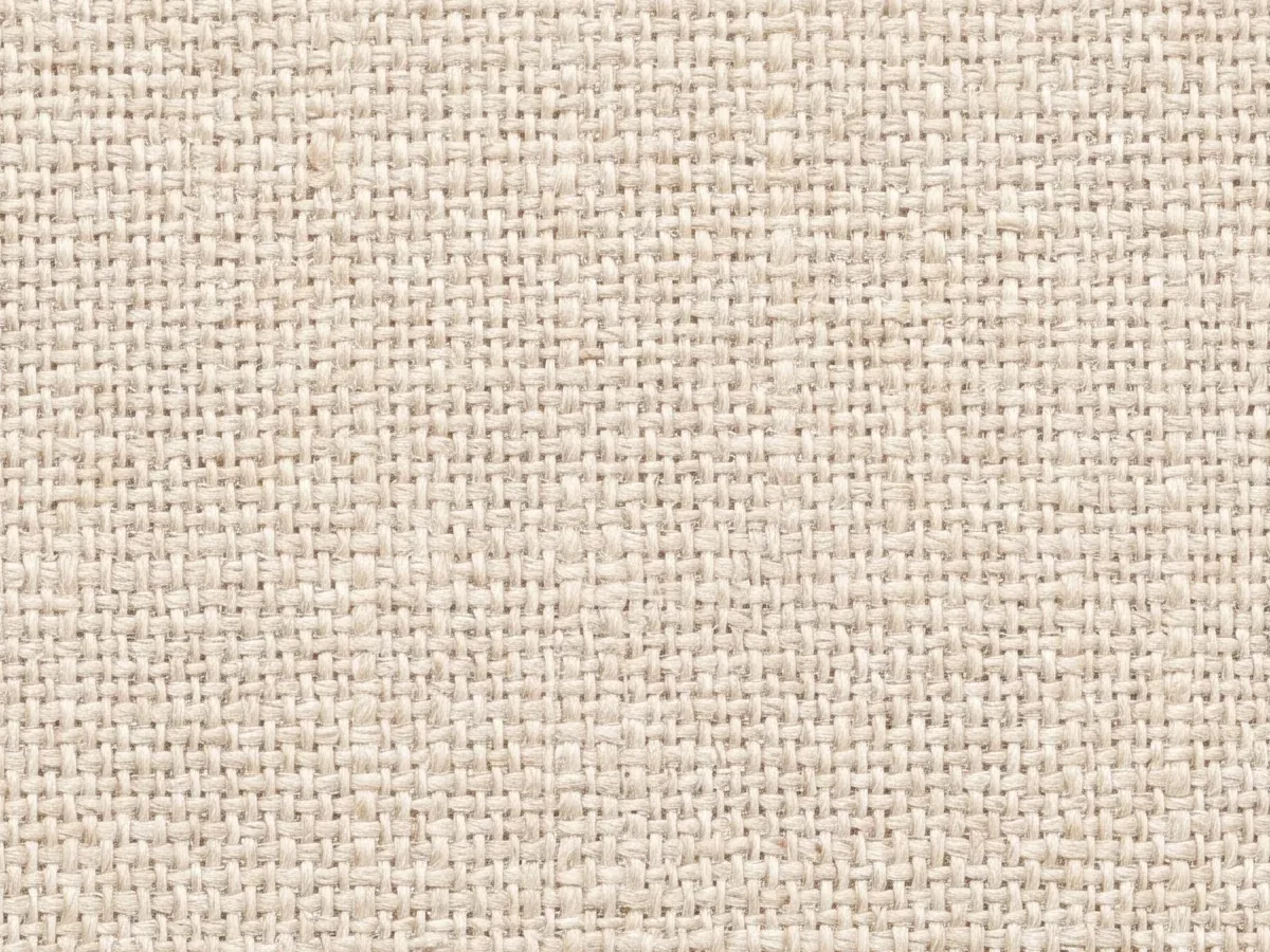 Close view of a plain light-coloured woven fabric face