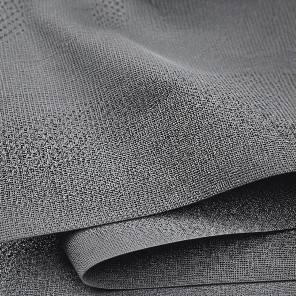 Close-up of grey technical woven cycling fabric folded back on itself