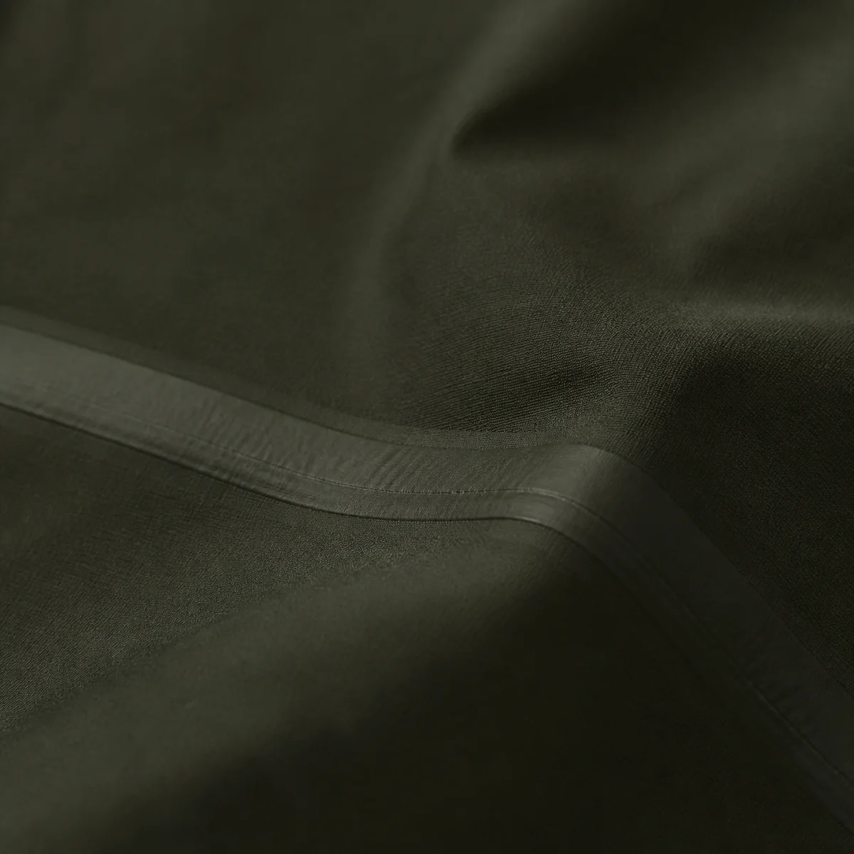 Dark shell fabric of a packable outer layer, folded
