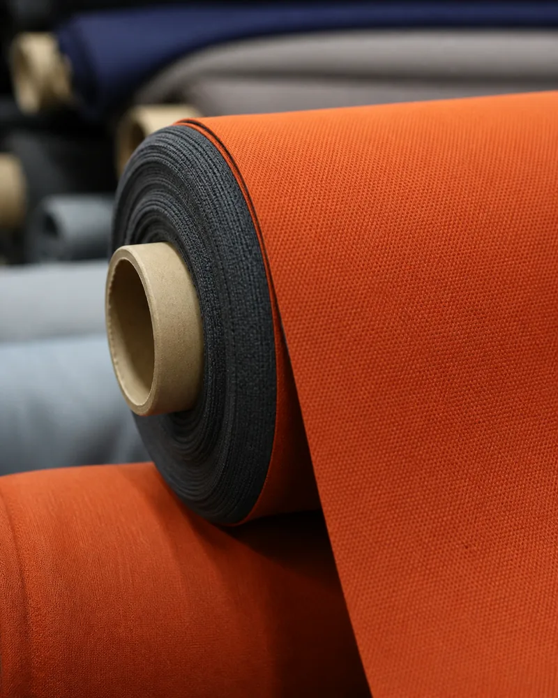 Rolled cycling apparel fabric sample in a factory setting