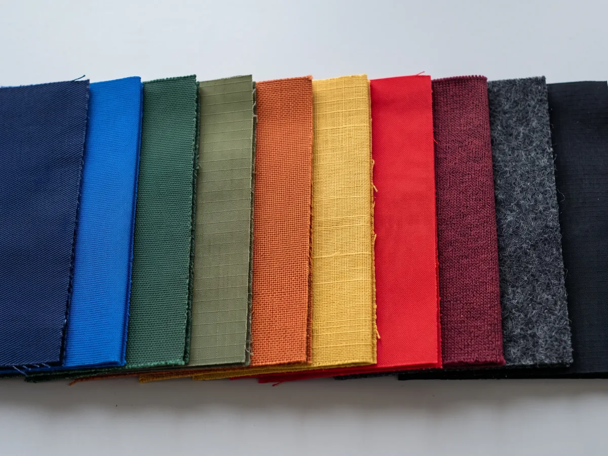 Layered fabric samples in several colours stacked edge-on