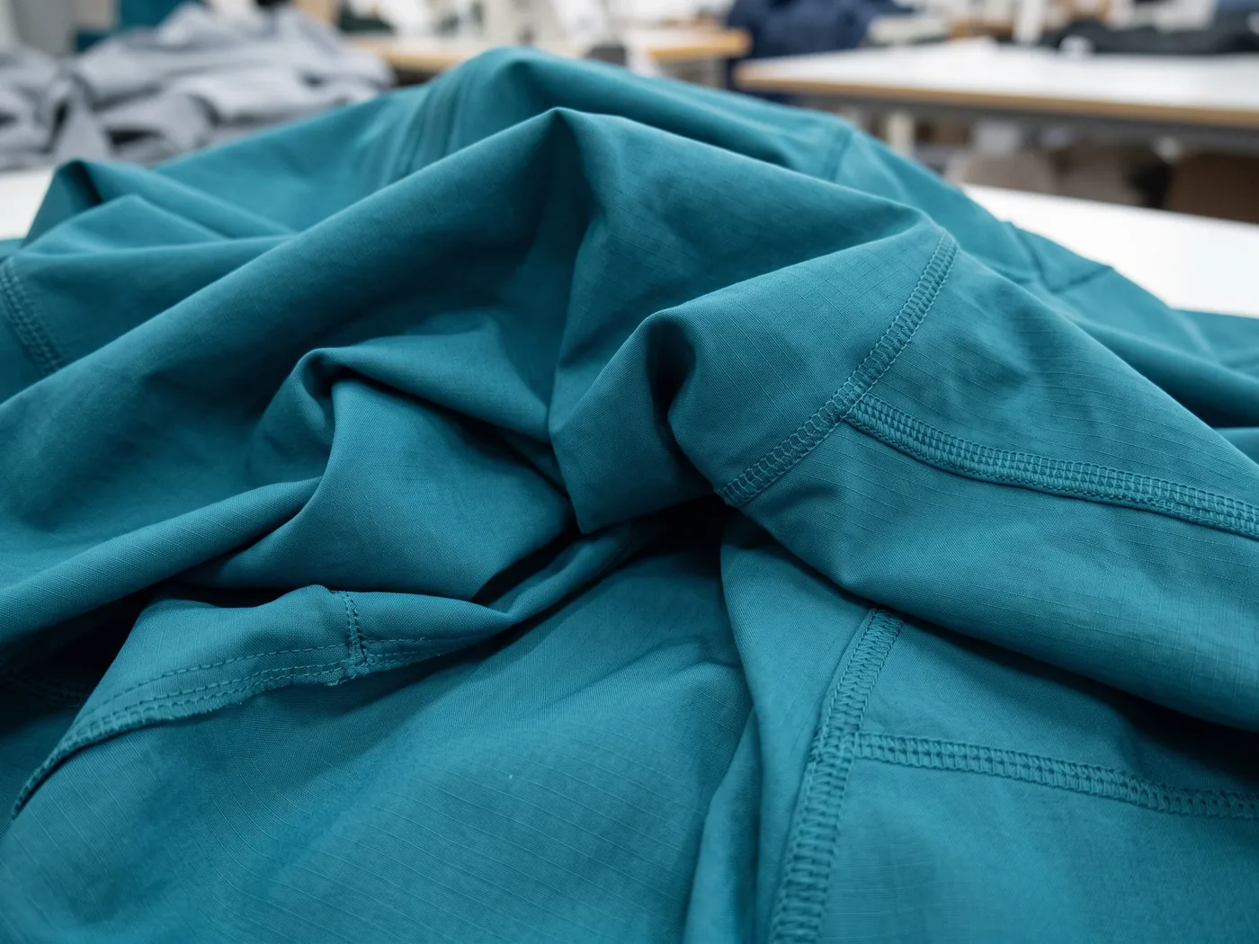 Folds of a teal technical nylon fabric