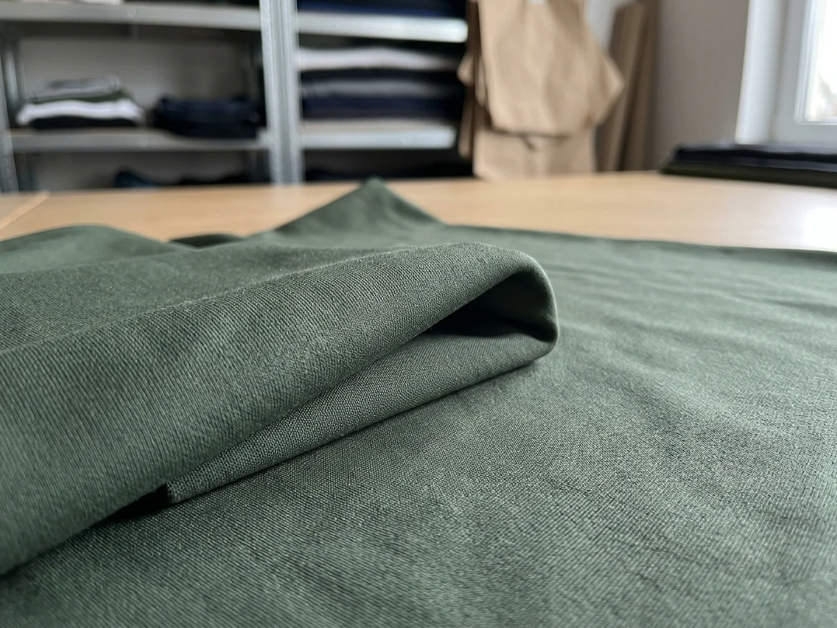 Macro of dense green body fabric folding on itself